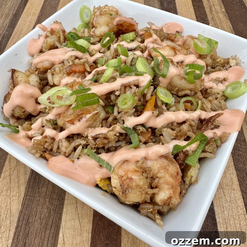 Flavorful Shrimp Fried Rice 2 Delicious Shrimp Fried Rice cooked on a griddle, ready to be served.