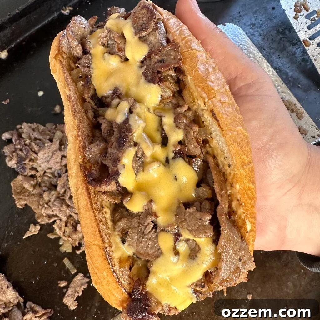 Delicious classic Philly Cheesesteak sandwich with melted cheese and onions