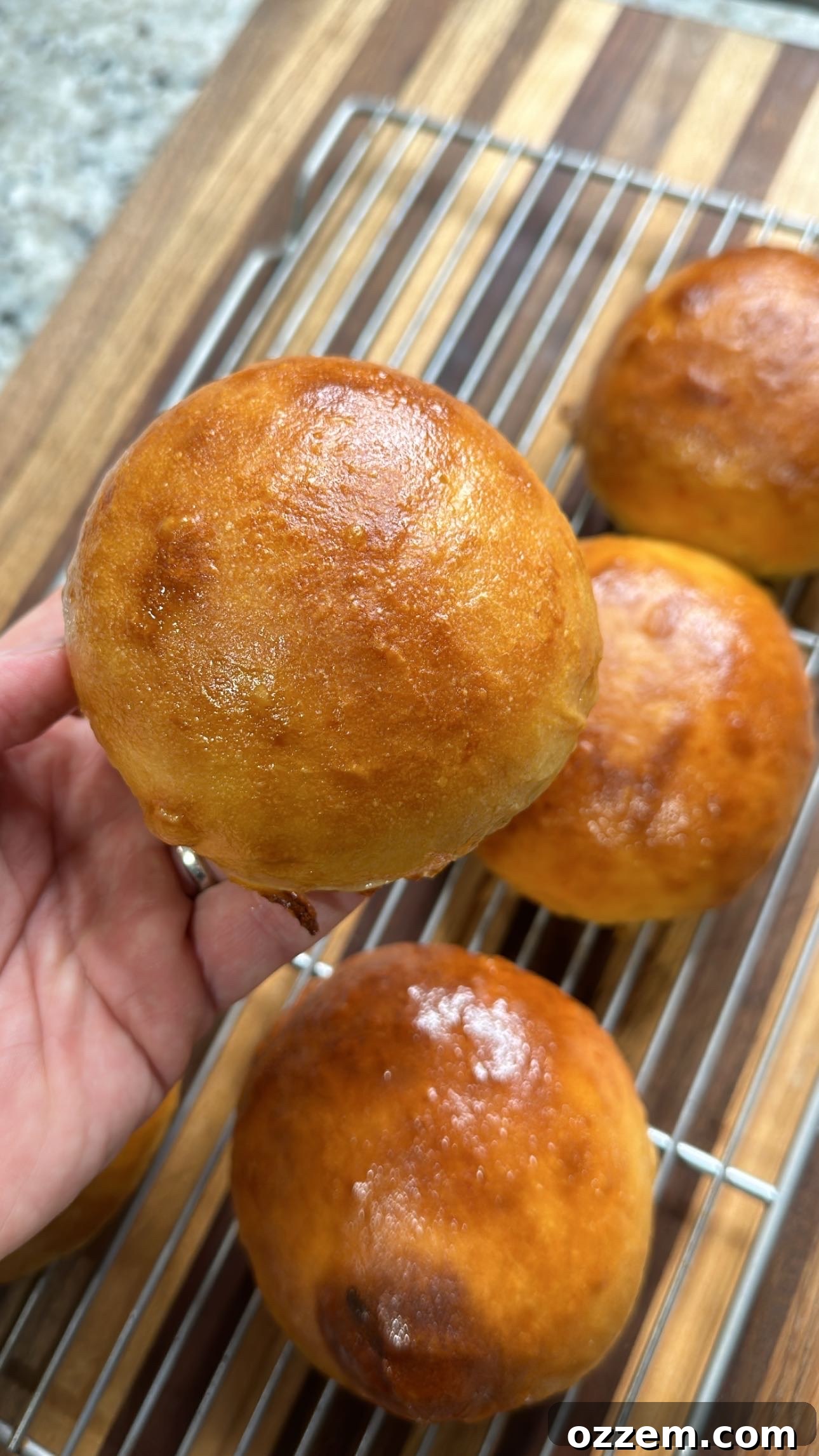 Soft, fluffy homemade burger buns cooling on a rack