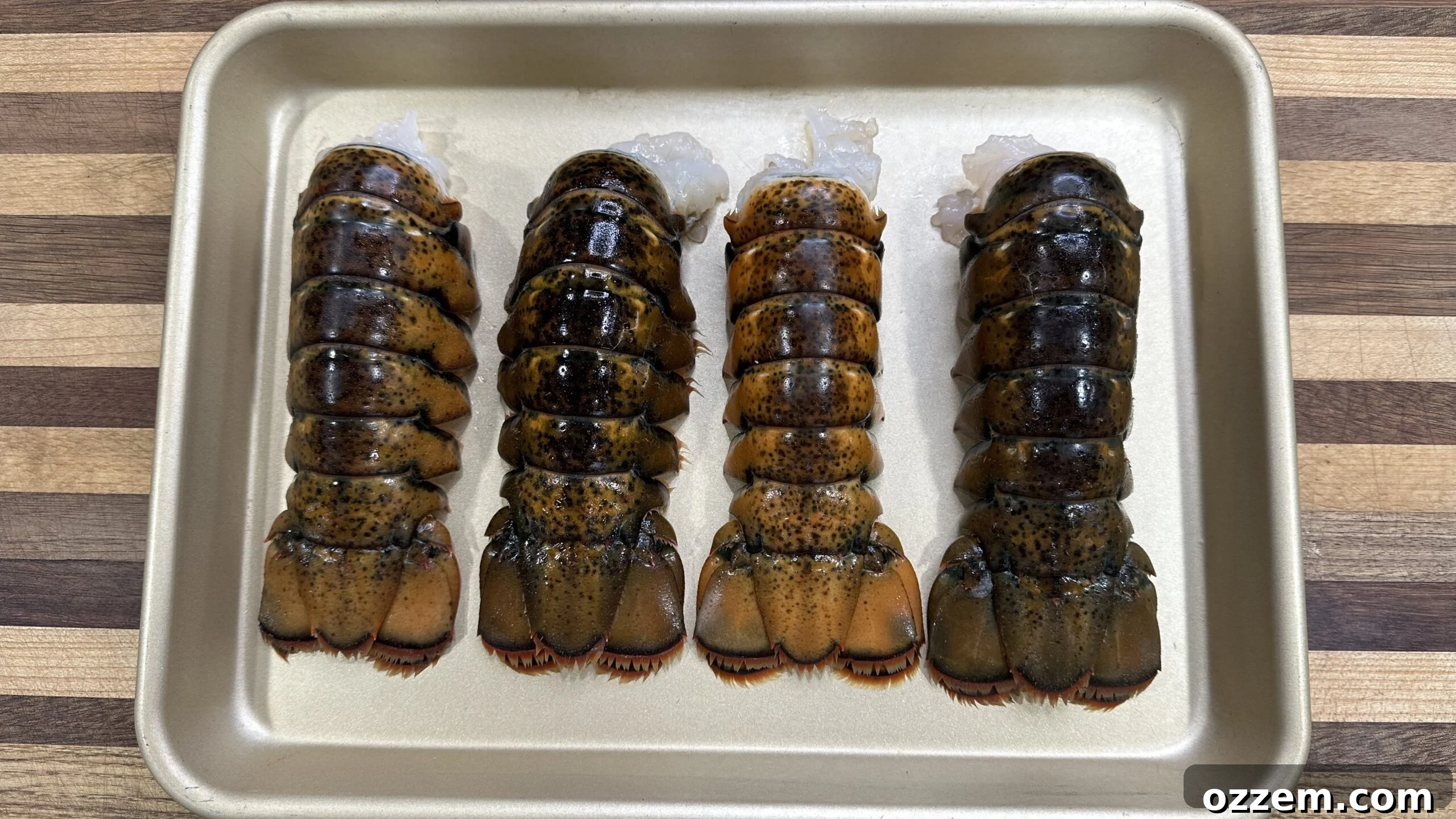Fresh lobster tails prepared for skewering, showcasing the tender meat.