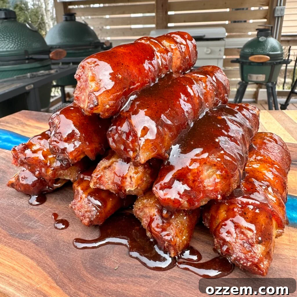 Finished BBQ shotgun shells, beautifully glazed with BBQ sauce, arranged on a cutting board, ready to be enjoyed.