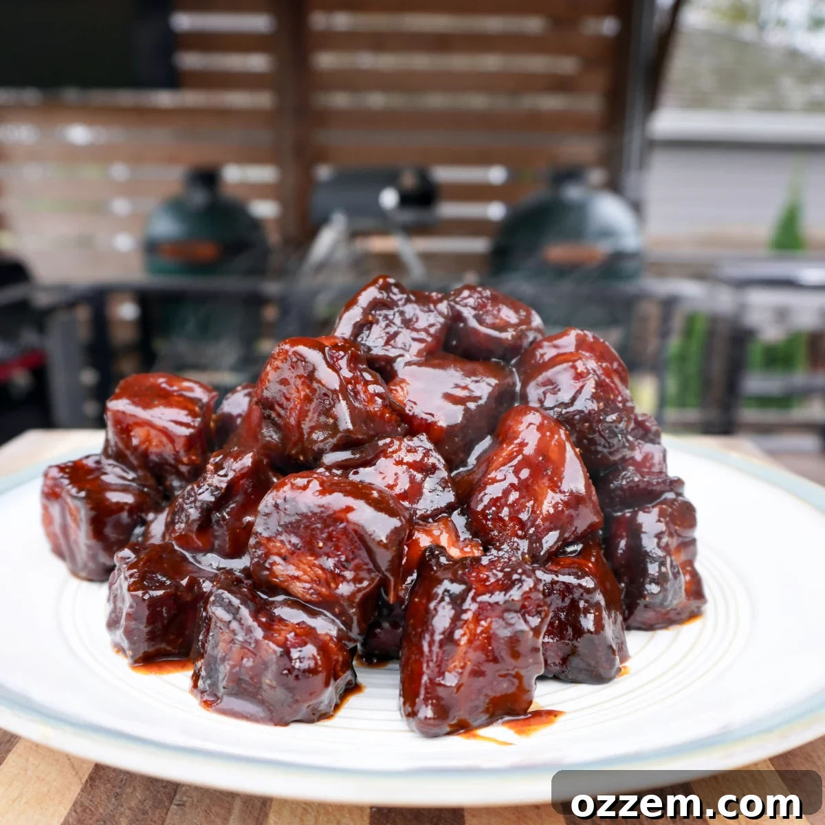 pork belly burnt ends on a plate, glistening with maple bourbon glaze.