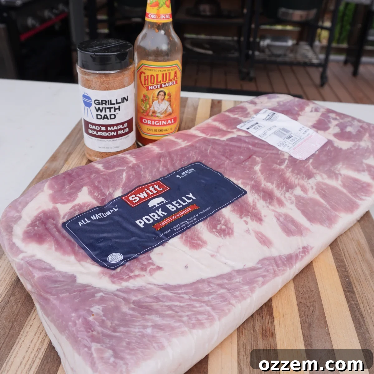 Raw pork belly slab on a cutting board, ready for preparation.