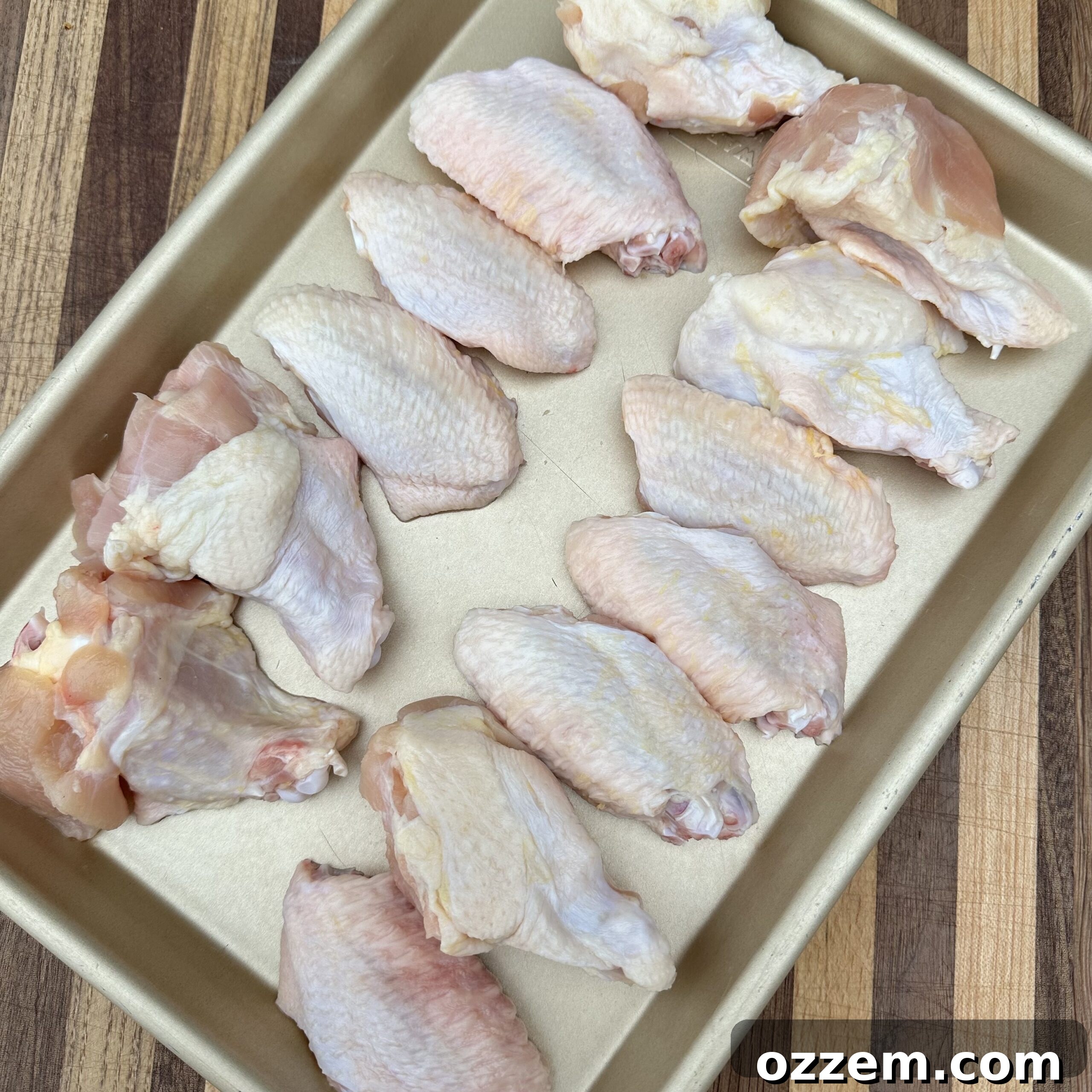 Raw chicken wings seasoned and ready for grilling