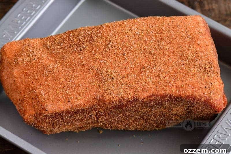 Pulled Pork Perfection 4 Raw pork shoulder generously rubbed with a dark blend of spices, ready for the smoker.