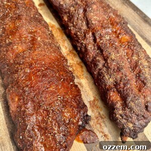 Plated Memphis Style Ribs with a rich, dark crust, garnished with fresh parsley.