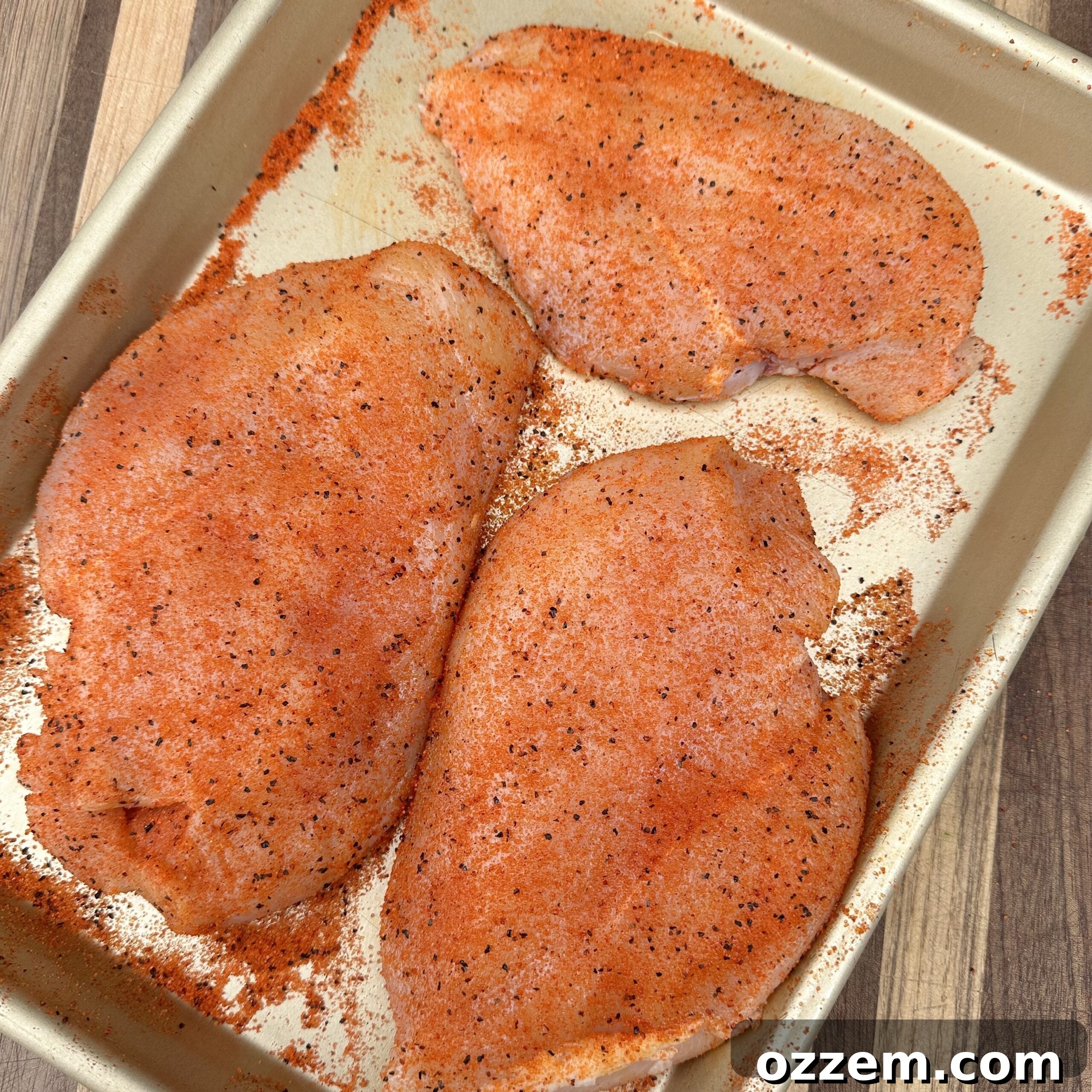 Seasoned chicken breasts, ready for the grill