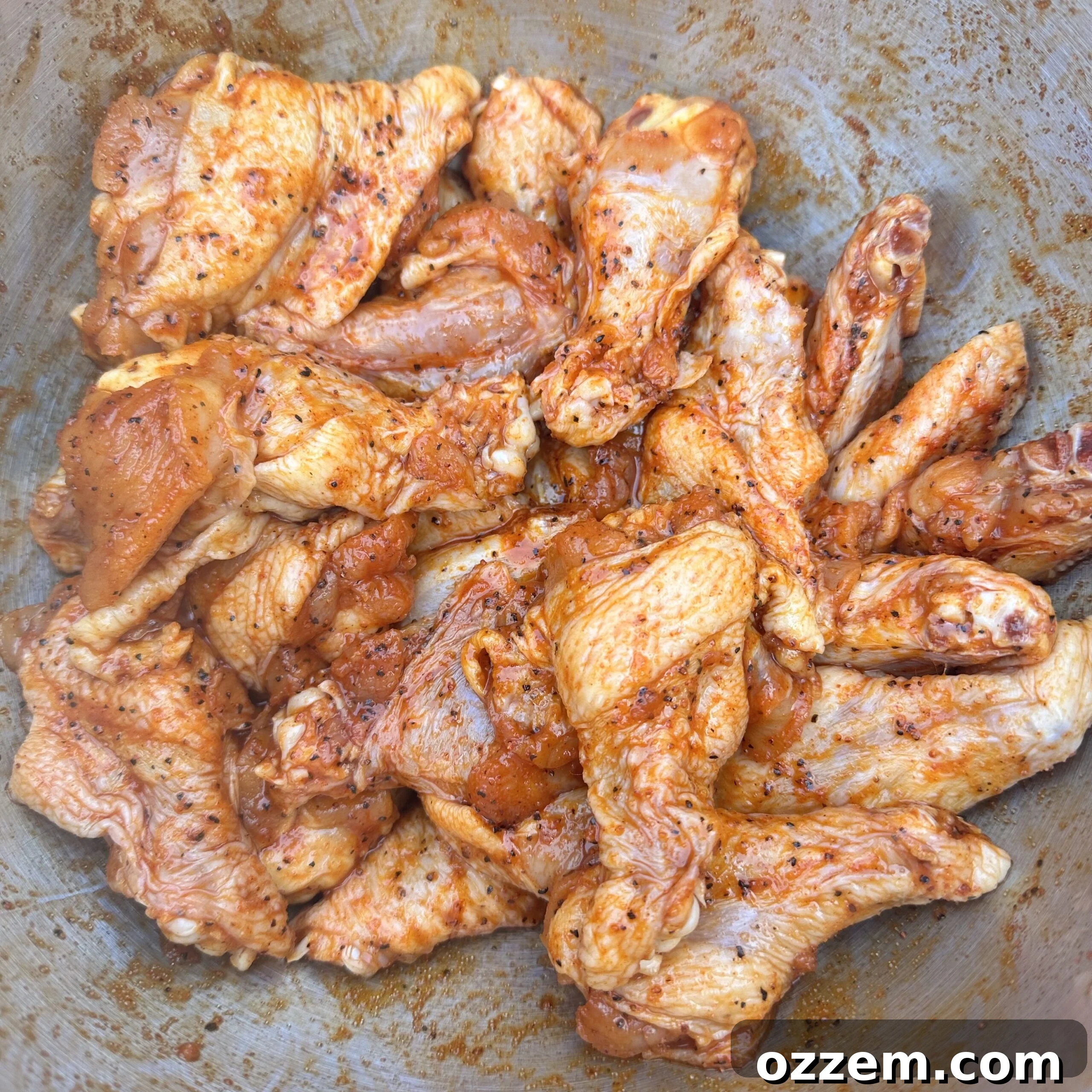 Seasoned chicken wings ready for the grill.