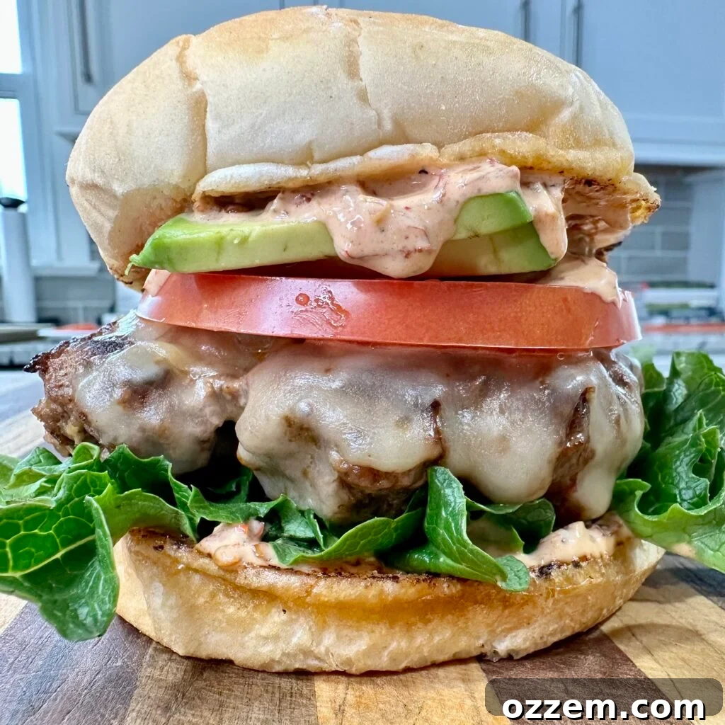 A perfectly grilled Chipotle burger, showcasing the smoky patty, melted cheese, and fresh toppings.