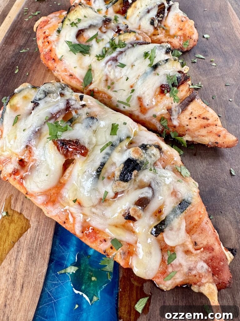 Grilled Hasselback Chicken stuffed with vegetables and melted cheese, ready to serve.