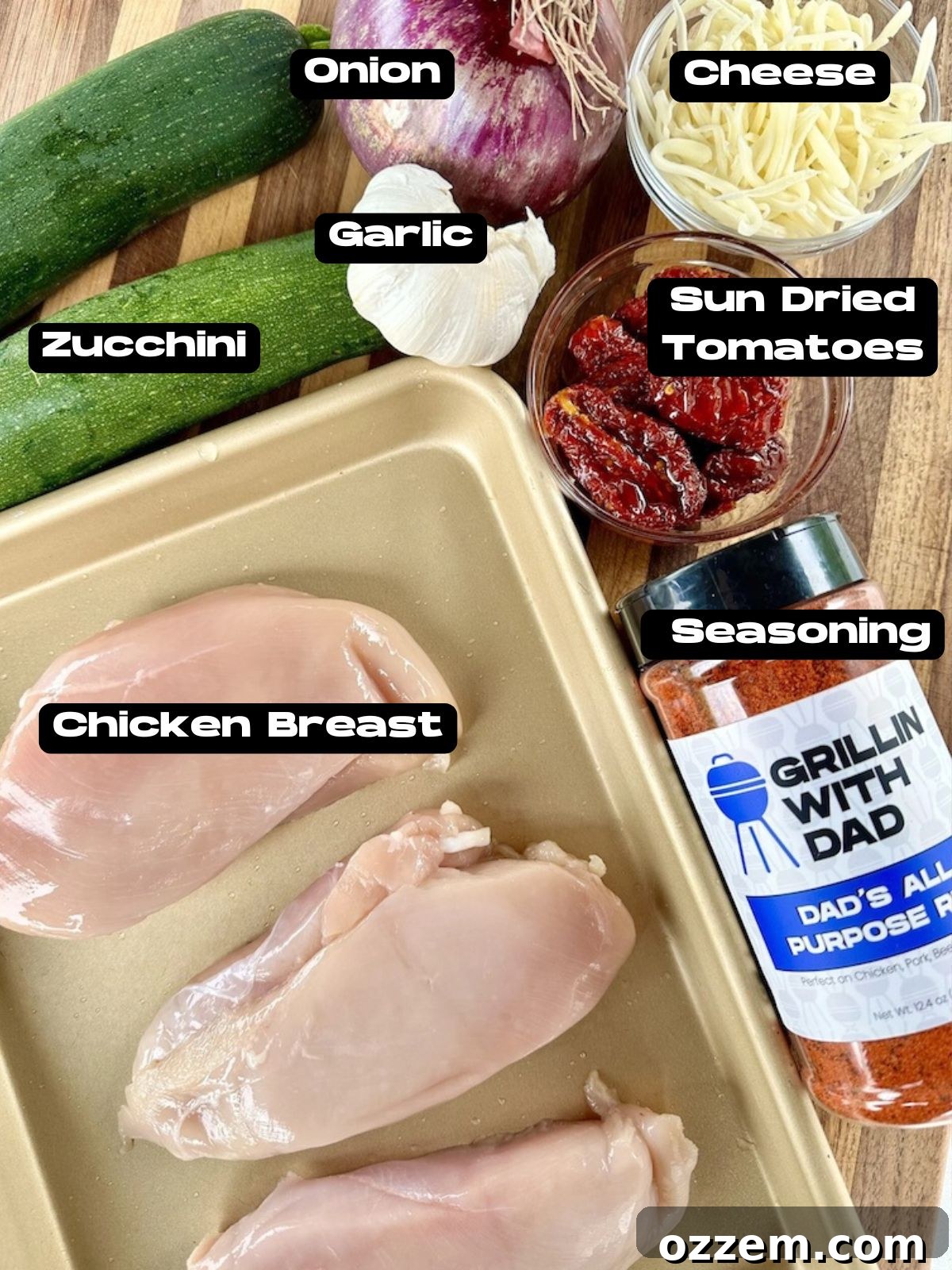 A selection of fresh ingredients including chicken breast, zucchini, red onion, sun-dried tomatoes, and mozzarella for Hasselback chicken.