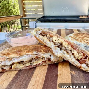 Stacked Breakfast Crunchwraps on a cutting board, ready to be sliced.