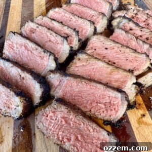 A perfectly grilled NY Strip steak, ready to be sliced and served.