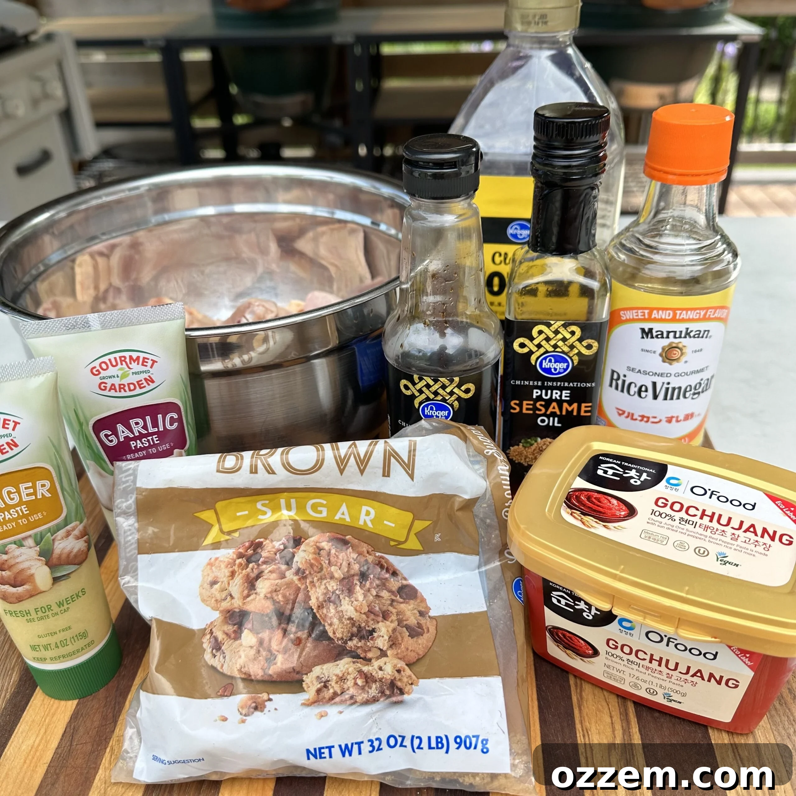Ingredients for gochujang sauce in separate bowls: gochujang, brown sugar, ginger paste, garlic paste, sesame oil, rice vinegar, honey, and soy sauce.