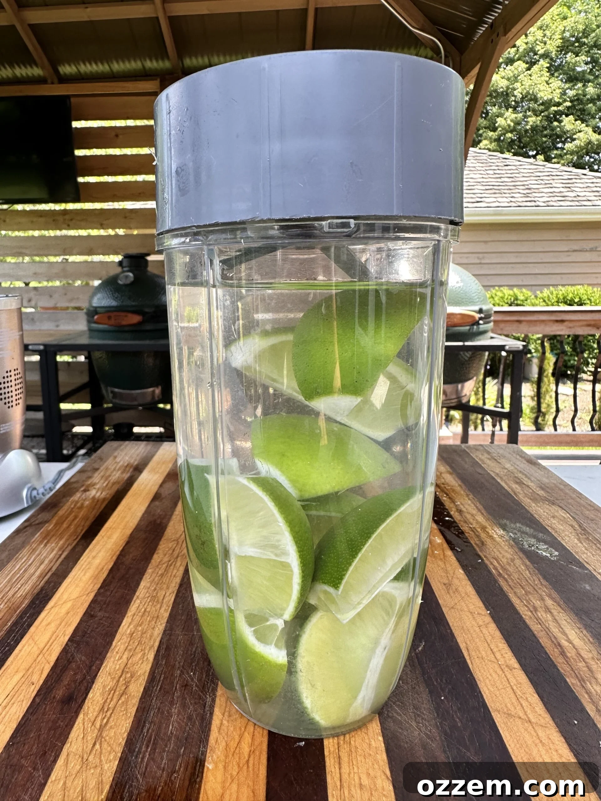 Limes, water, and condensed milk blending into a creamy green mixture, ready to become Brazilian Lemonade.