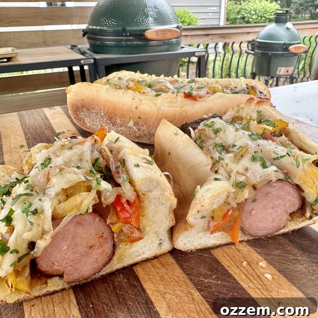 Two grilled sausage subs, perfectly sliced in half, revealing juicy sausage, colorful bell peppers, melted cheese, and a toasted bun.