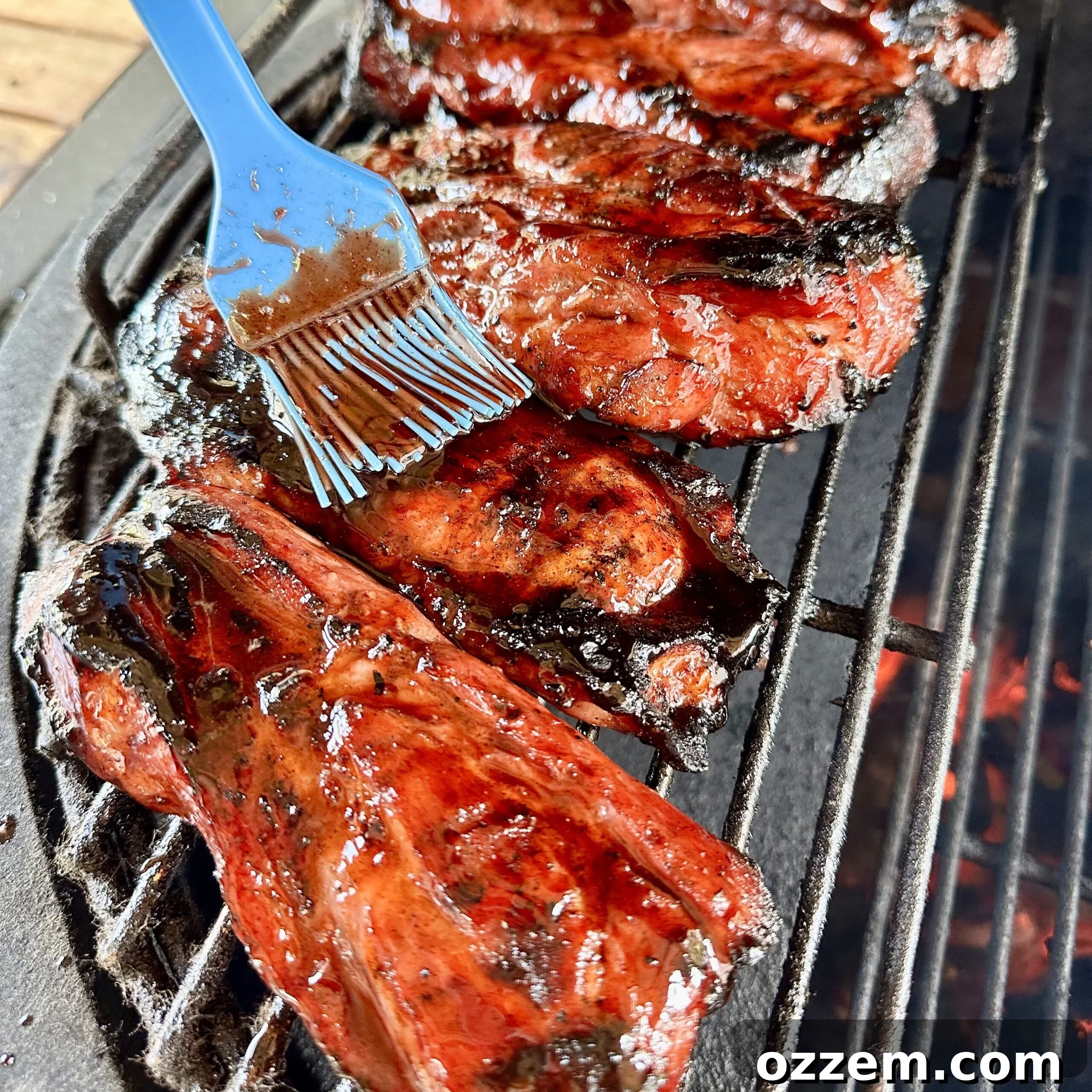Sticky Sweet Char Siu 6 Chinese BBQ Pork grilling on an outdoor barbecue with a vibrant red glaze.