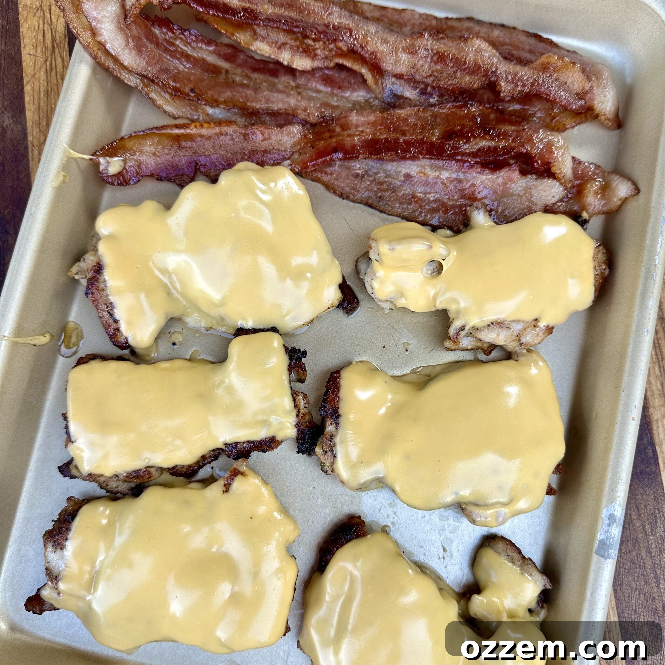 Perfectly melted cheese draped over a piece of cooked chicken