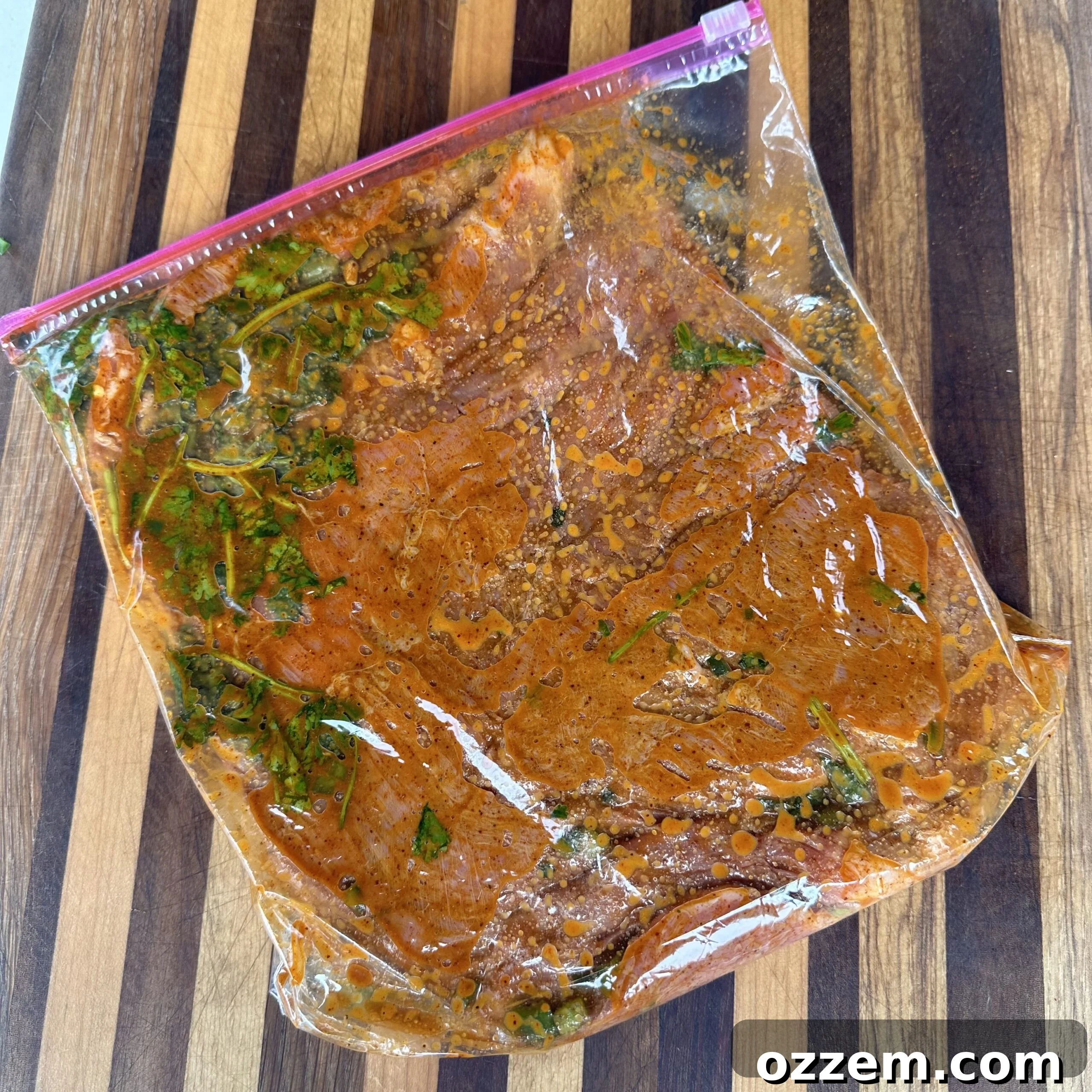 Flank steak marinating in a flavorful mixture