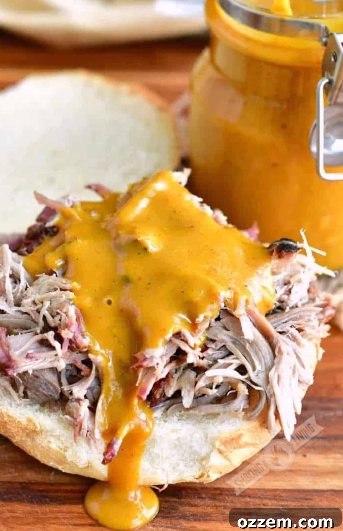 Pulled pork on a hamburger bun with Carolina mustard sauce on top.
