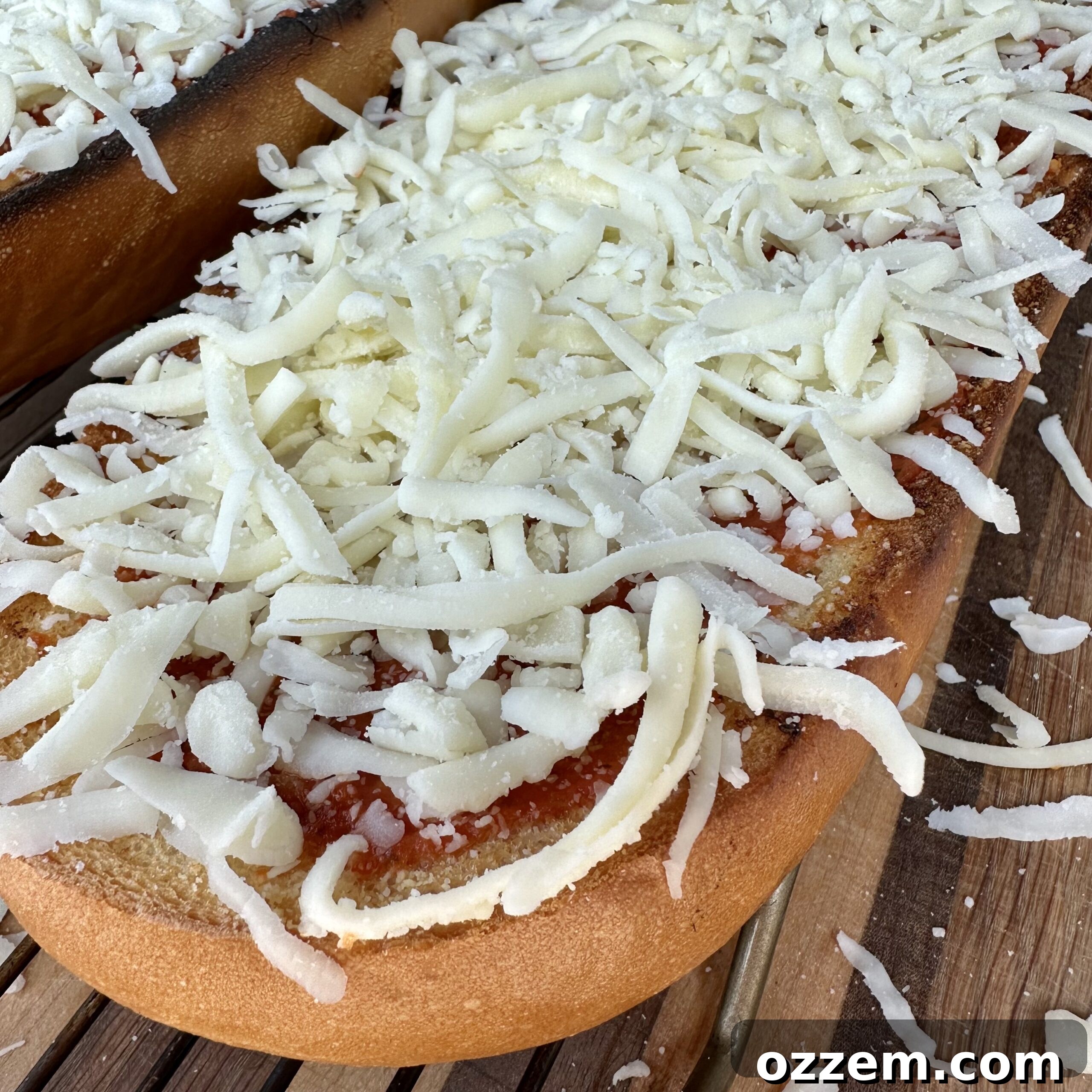 Loaded pizza bread with sauce, cheese, and various toppings, ready for final baking.