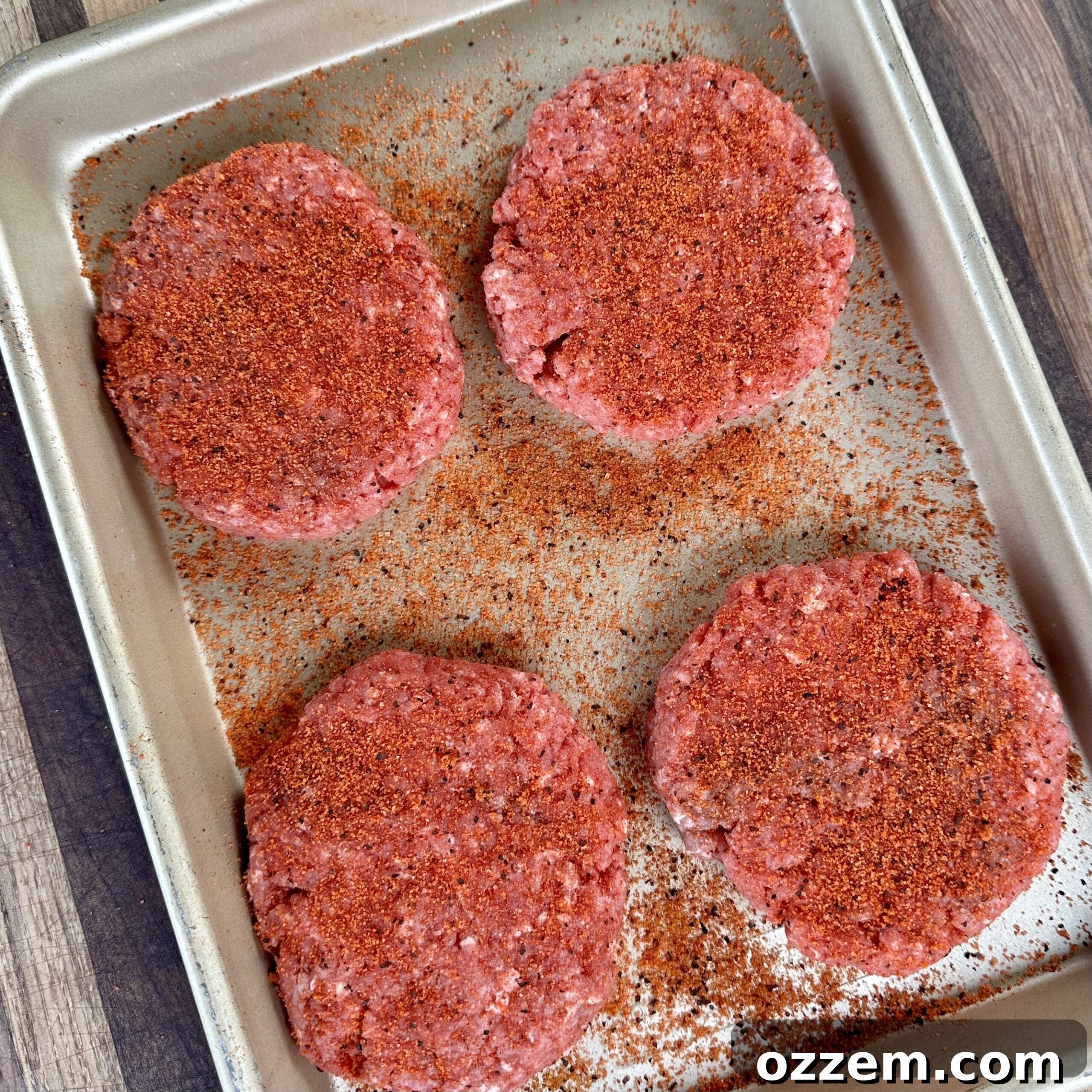 Freshly shaped beef patties for Hatch Chile Burgers, seasoned and ready for the grill.
