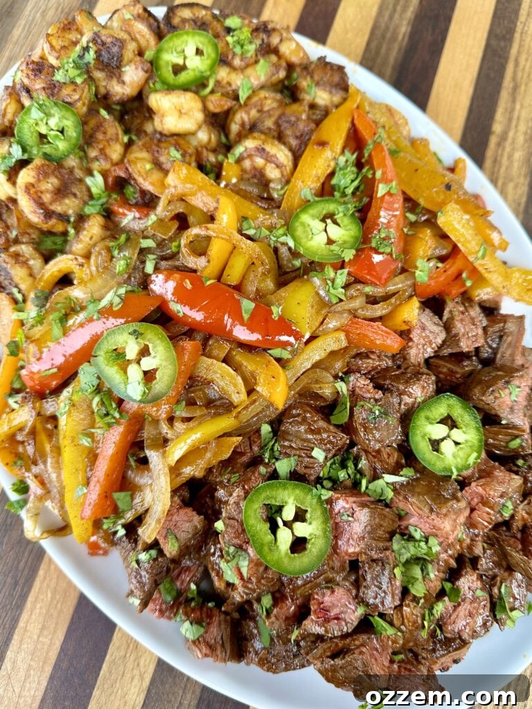 Steak and Shrimp Fajitas on a griddle