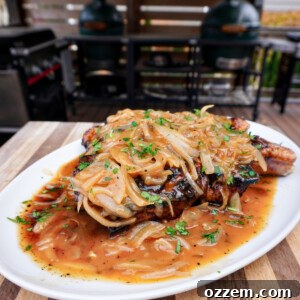 A beautifully plated beer brined and smothered pork chop.