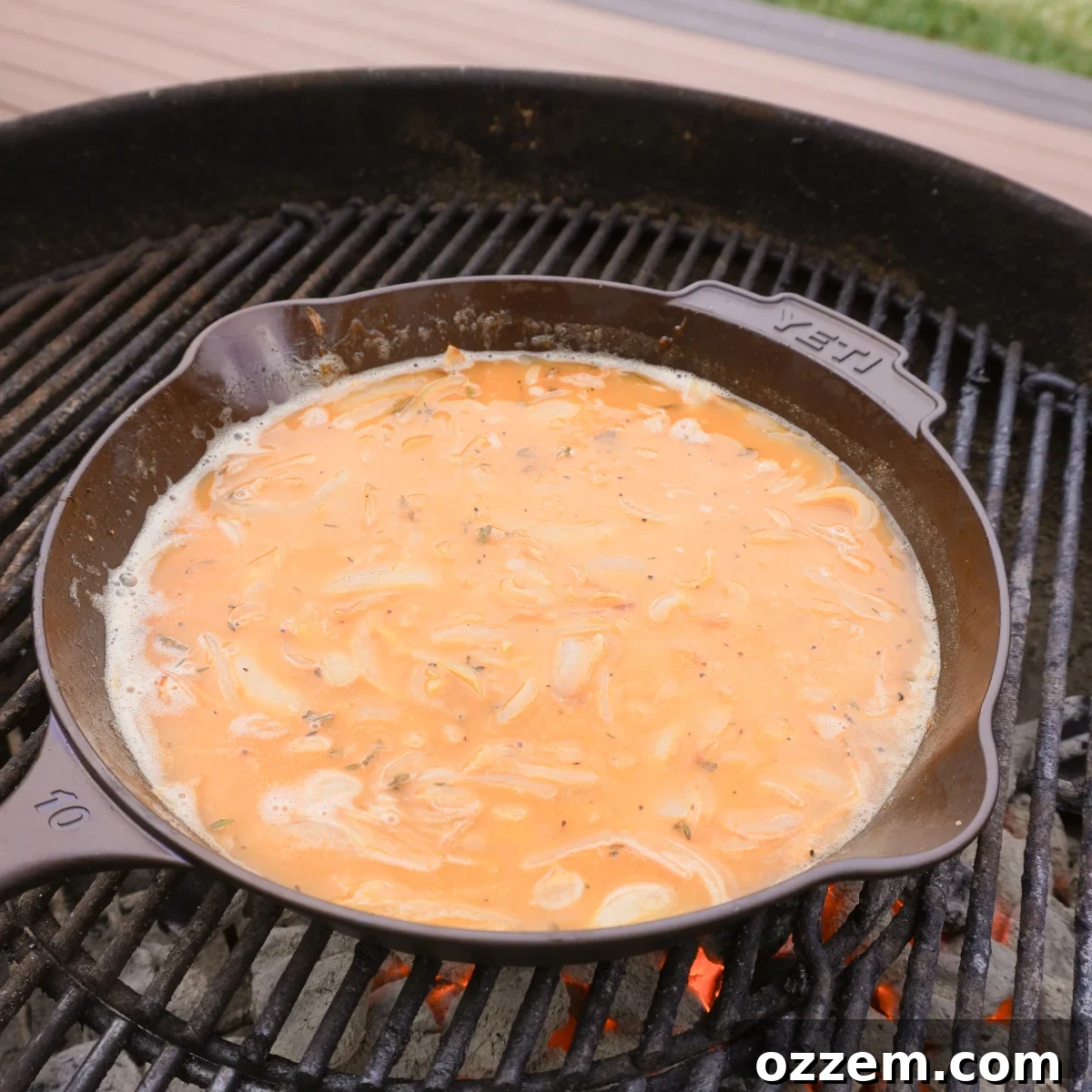 Succulent Pork Chops with Robust Beer Gravy 6 Close-up of rich, golden beer and onion gravy simmering in a cast iron skillet.