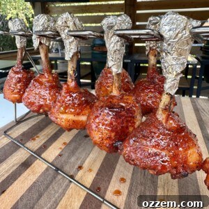 Bourbon Peach Chicken Lollipops 7 Close-up of a finished Peach and Whiskey Chicken Lollipop, glistening with glaze.