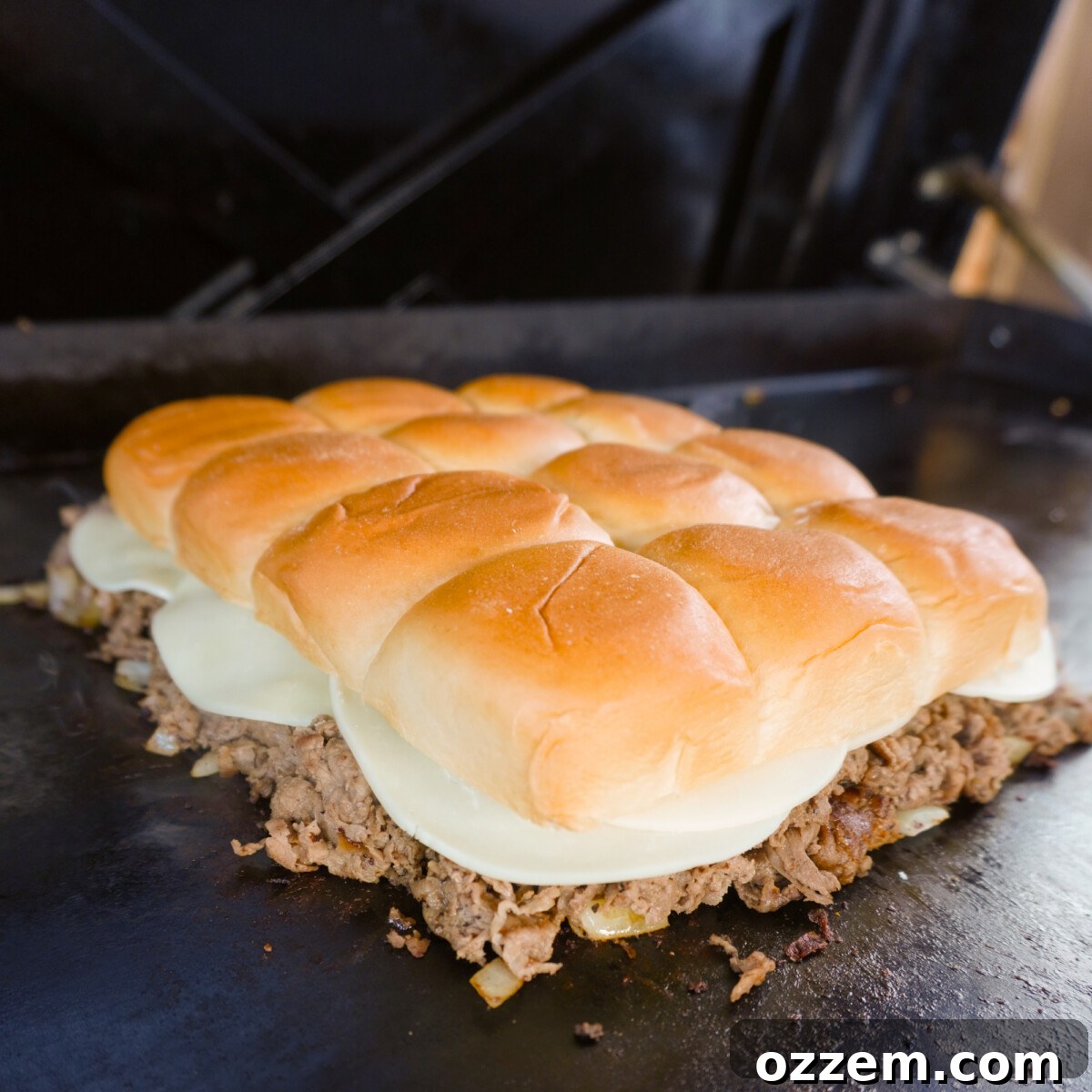 Cheesesteak sliders on the griddle.