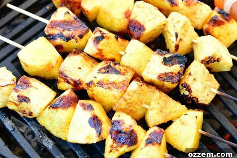 pineapple chunks on skewers on the grill