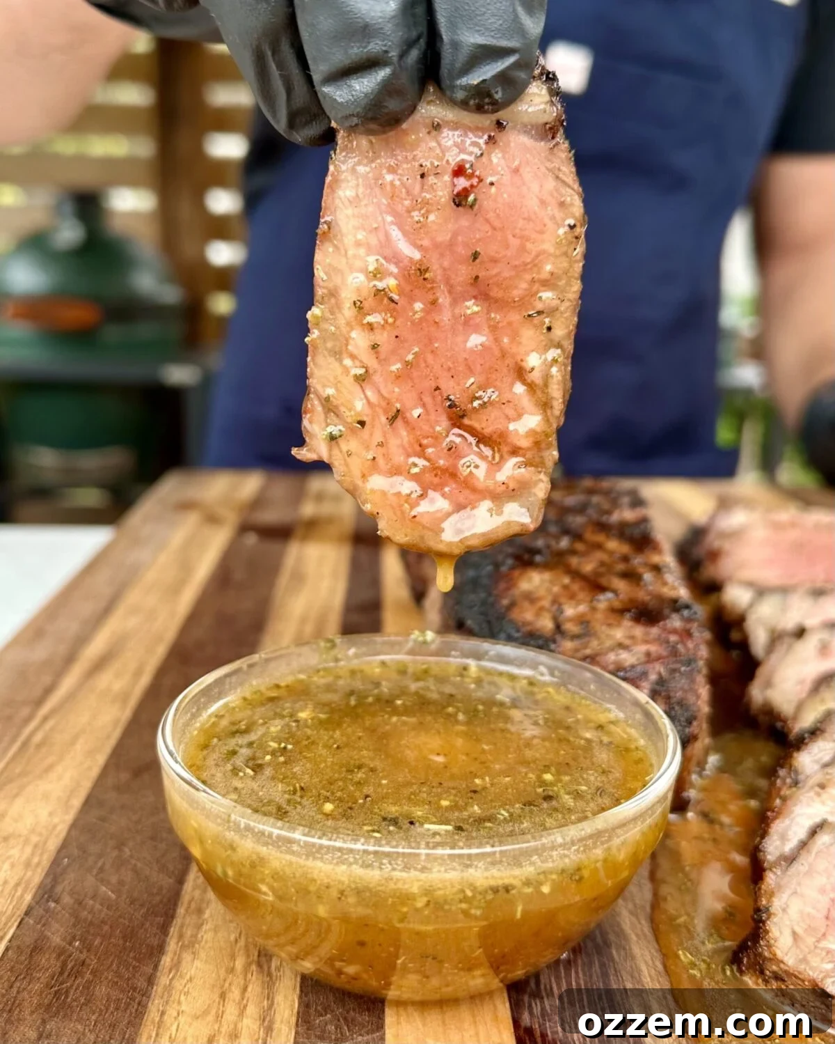 Close-up of sliced Cajun Honey Butter Steak, drenched in sauce, ready to be enjoyed.