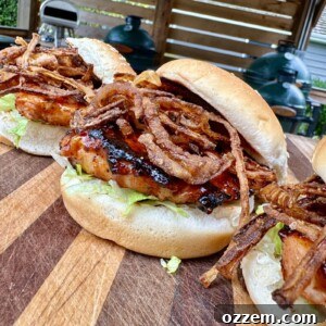A fully assembled grilled pork chop sandwich, ready to eat.
