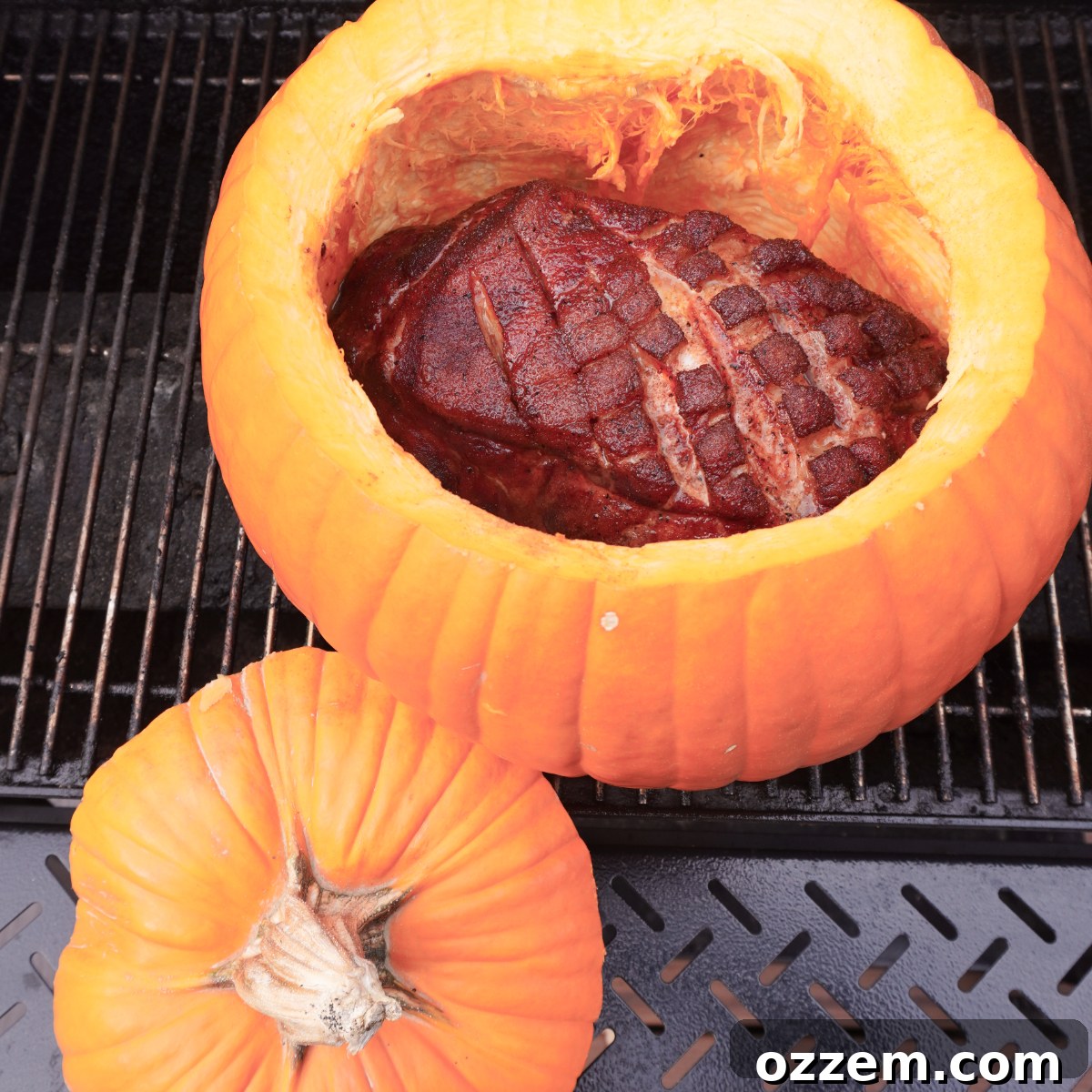 pork shoulder being placed inside the cleaned pumpkin