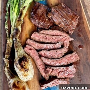 Plated marinated skirt steak with green onions and rice
