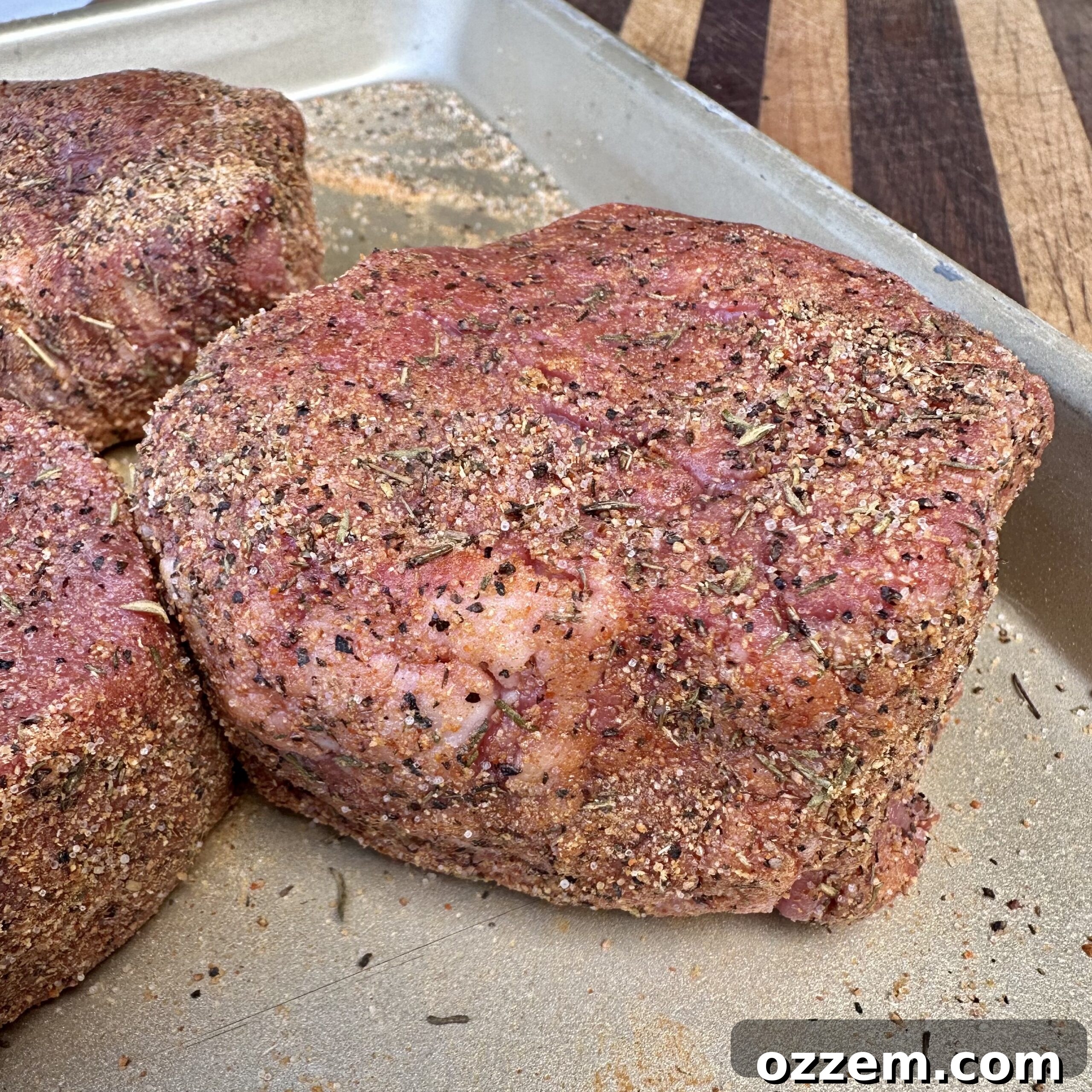 Succulent filet mignon seasoned generously with Dad's Steak Seasoning, ready for searing.