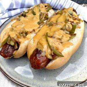Delicious Beer Cheese Hotdogs with sauce, peppers, and onions