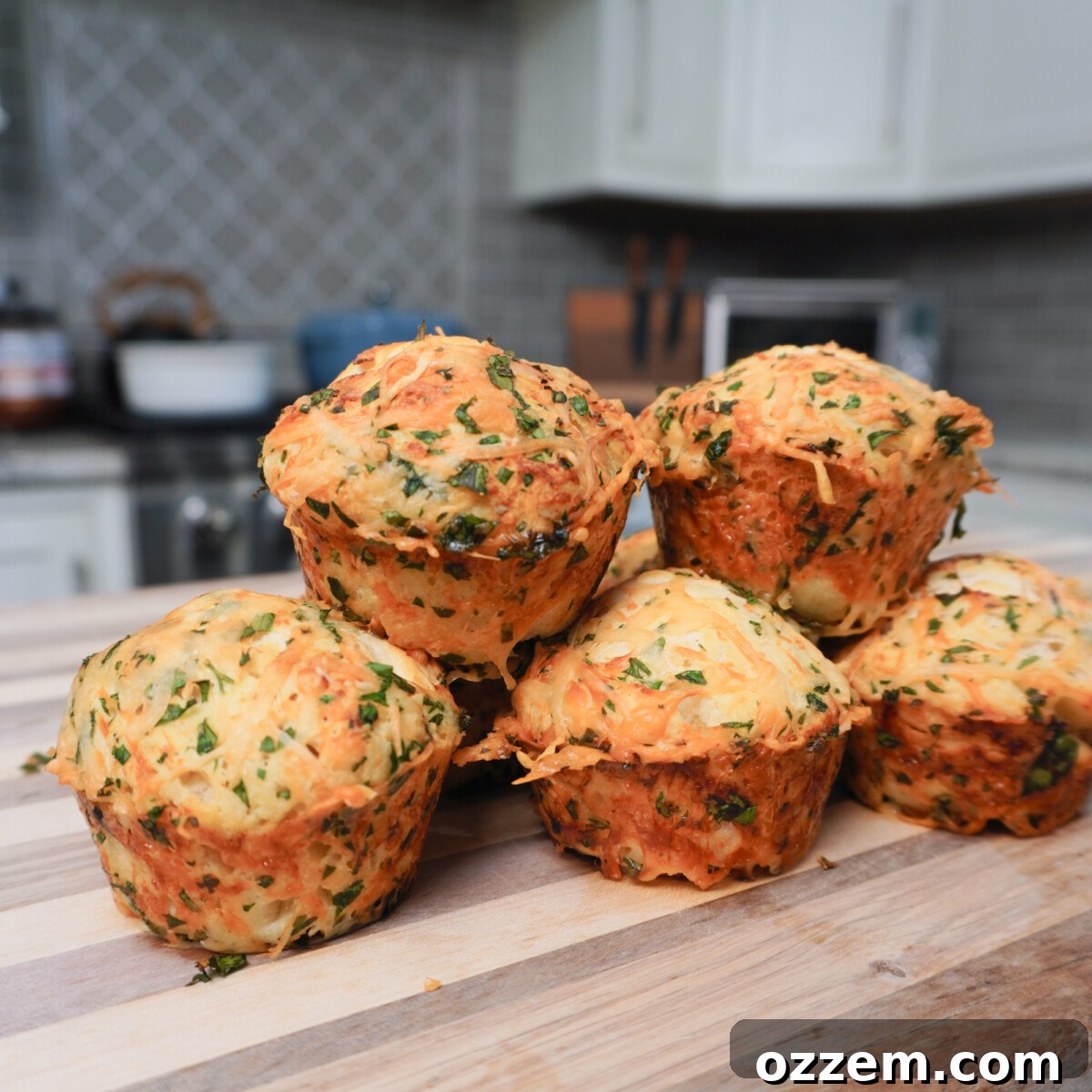 Savory Cheese Muffins 2 Golden brown cheesy dinner muffins fresh from the oven, ready to be served as a savory side dish.