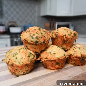 Savory Cheese Muffins 7 A close-up of a cheesy dinner muffin showing its golden crust and fluffy interior.