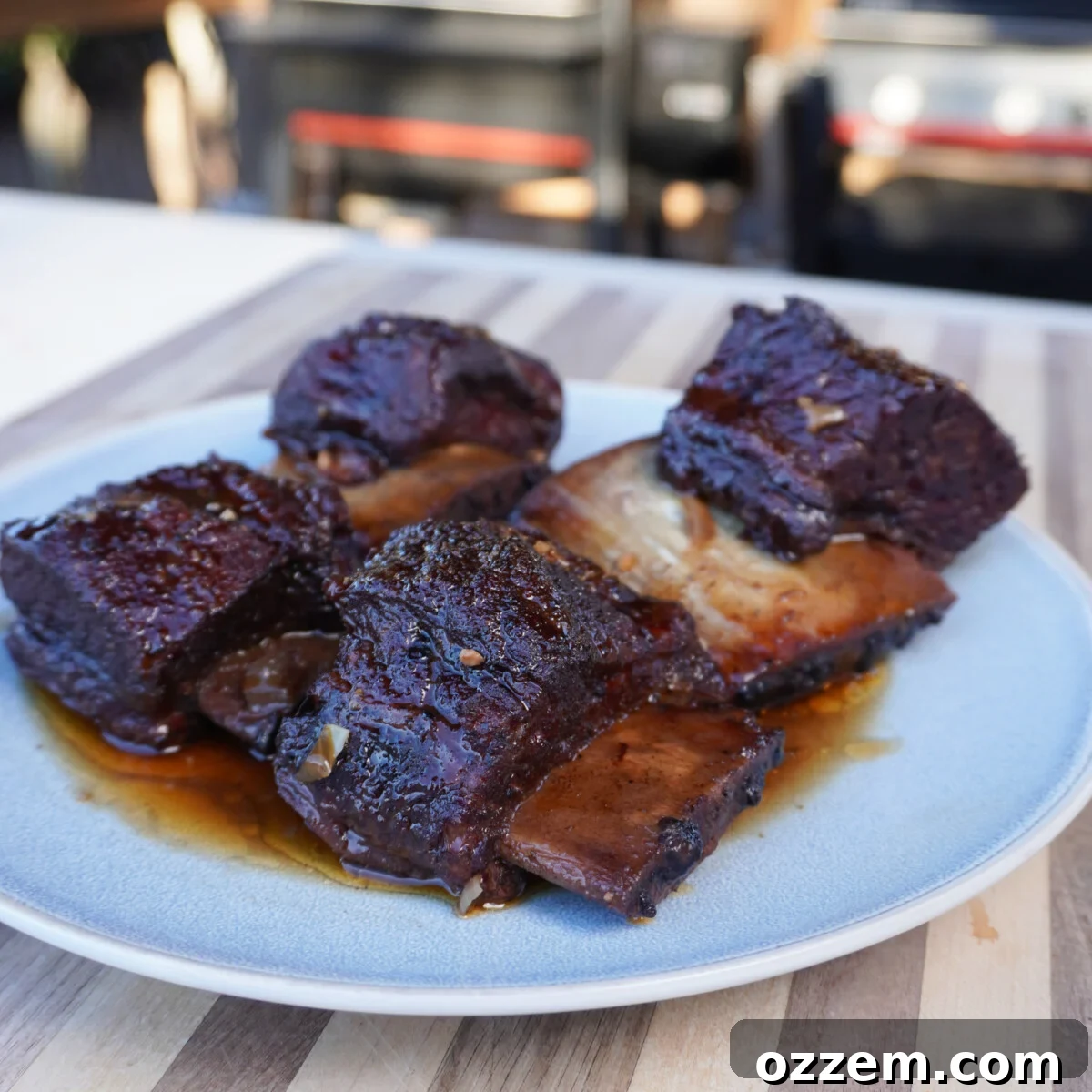 Velvet Smoke Ribs 13 Exquisitely cooked short ribs elegantly plated, drenched in a rich, glossy sauce, ready to be savored.