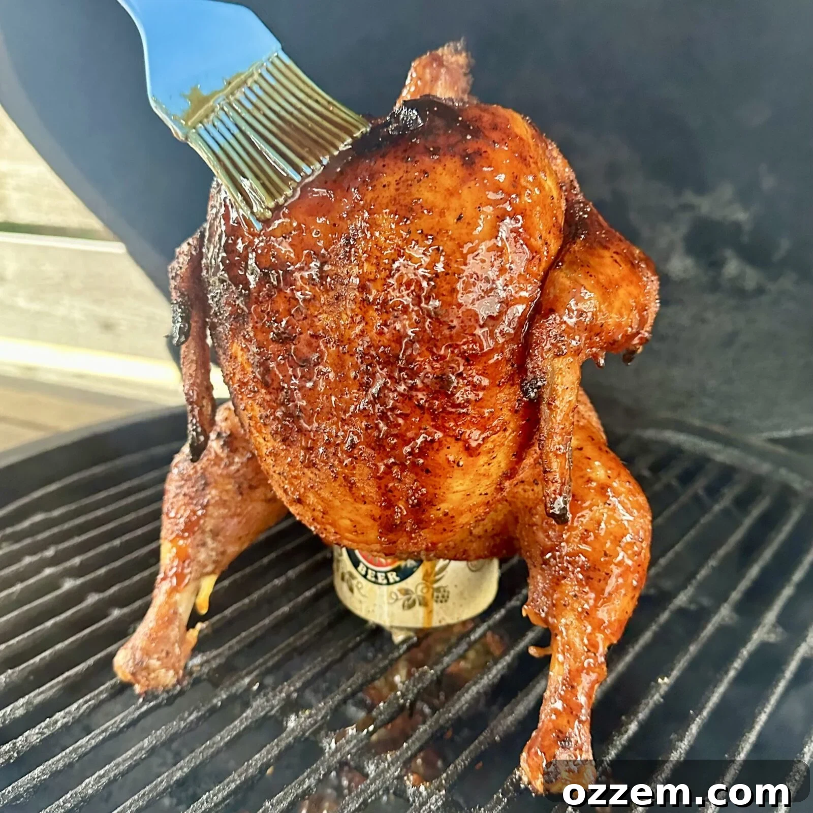 Juicy smoked beer can chicken brushed with homemade BBQ sauce