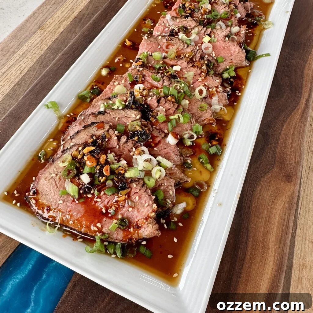 Grilled Beef Tataki served with ponzu sauce and fresh toppings