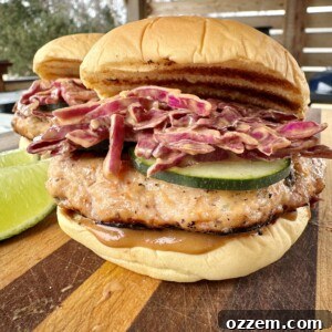 A close-up of a Thai Inspired Chicken Burger with peanut slaw.