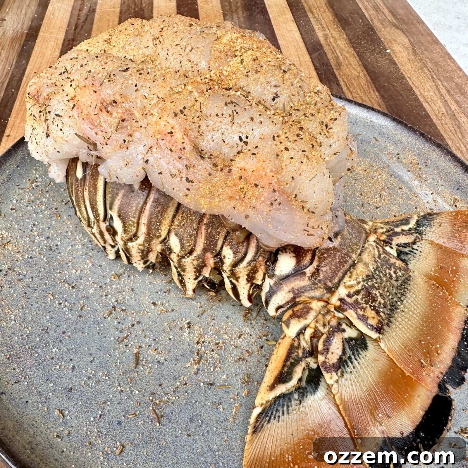 Seasoned butterfly lobster tail ready for grilling