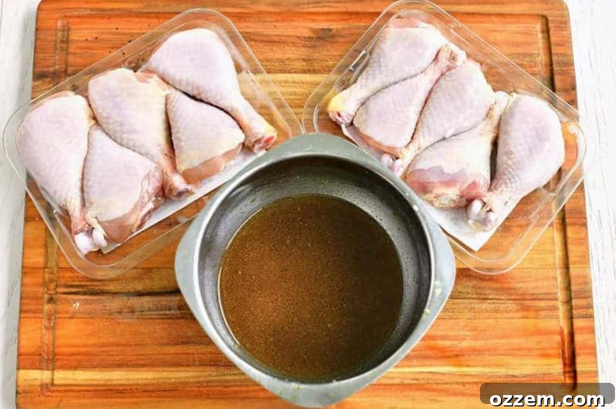 chicken legs in the plastic package on a wood cutting board with a bowl of marinade.