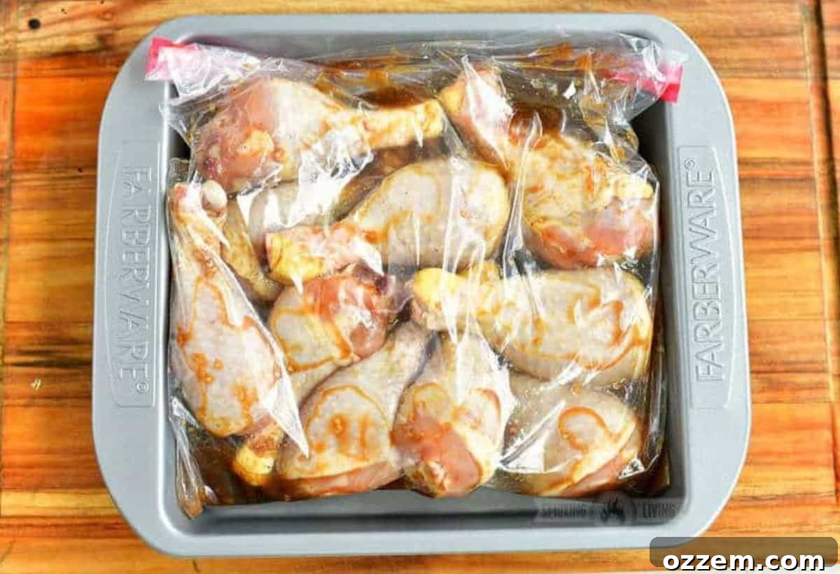 Chicken legs in a bag with marinade in a baking dish.