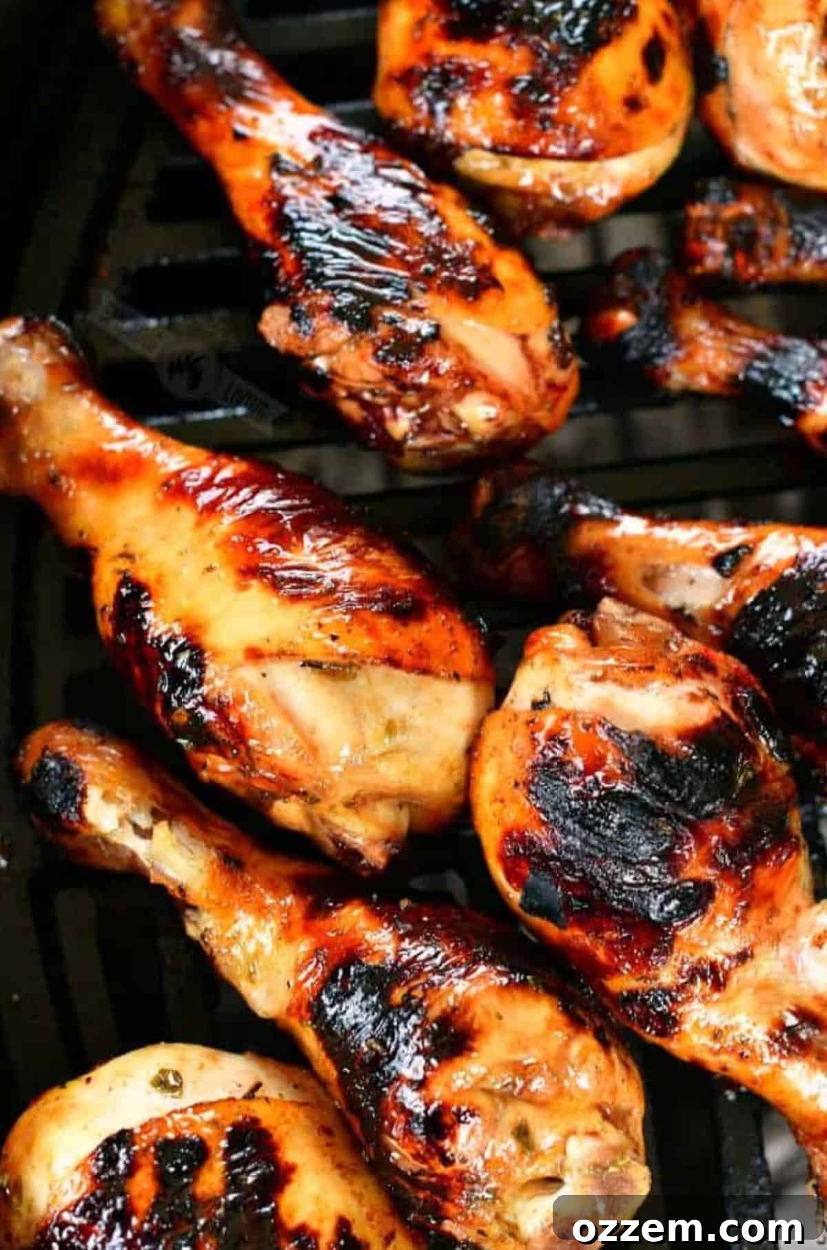 Marinated grilled chicken legs on the grill.