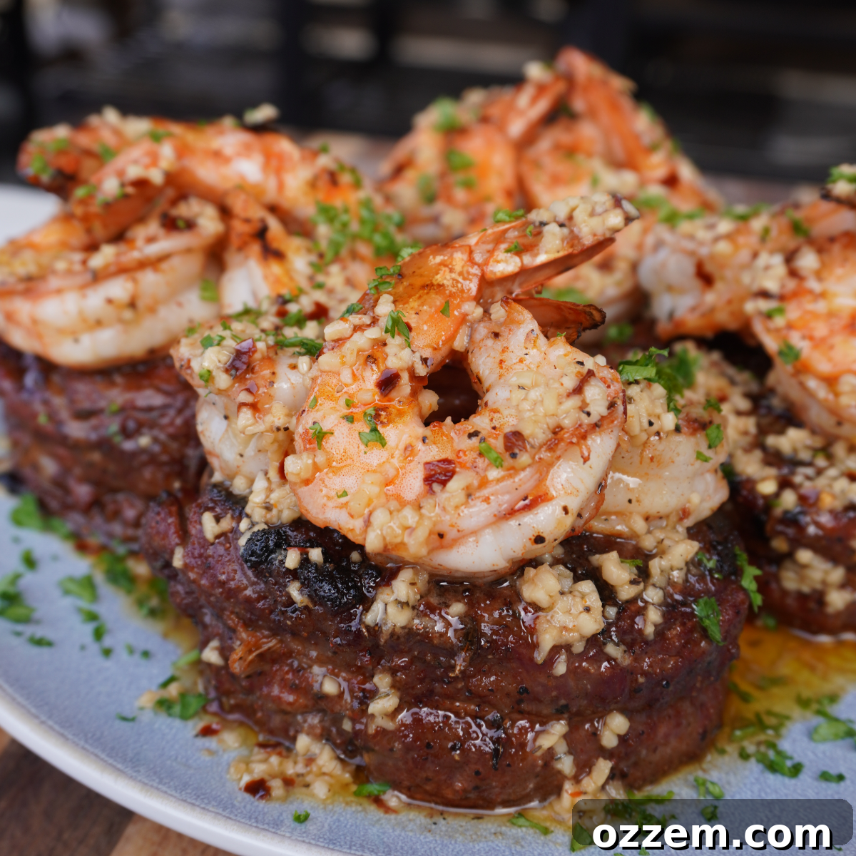 Capstone Surf & Turf 7 Plated Ribeye Cap Surf & Turf drizzled with garlic butter and parsley.