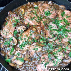 Grilled Veal Medallions in Marsala Sauce 7 A close-up of grilled veal marsala, glistening with rich sauce and fresh parsley, presented as a delicious, ready-to-serve Italian dish.